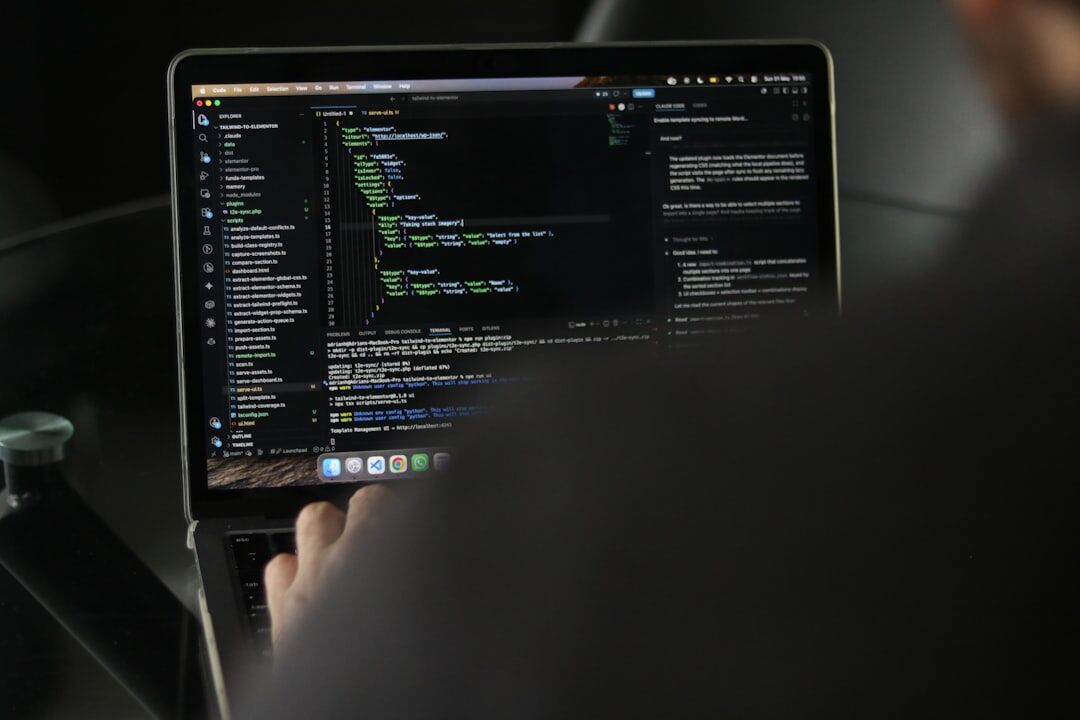 programmer coding on laptop
